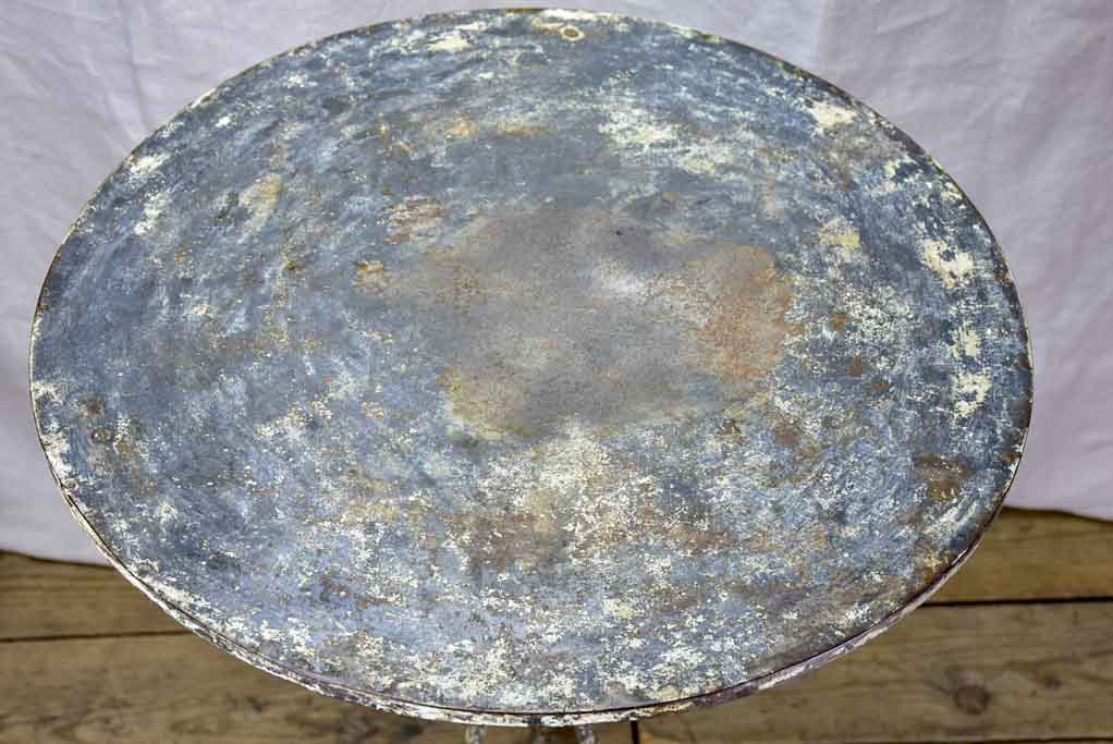 Antique French bistro table with timeworn beige patina