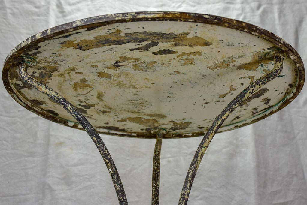 Antique French bistro table with timeworn beige patina