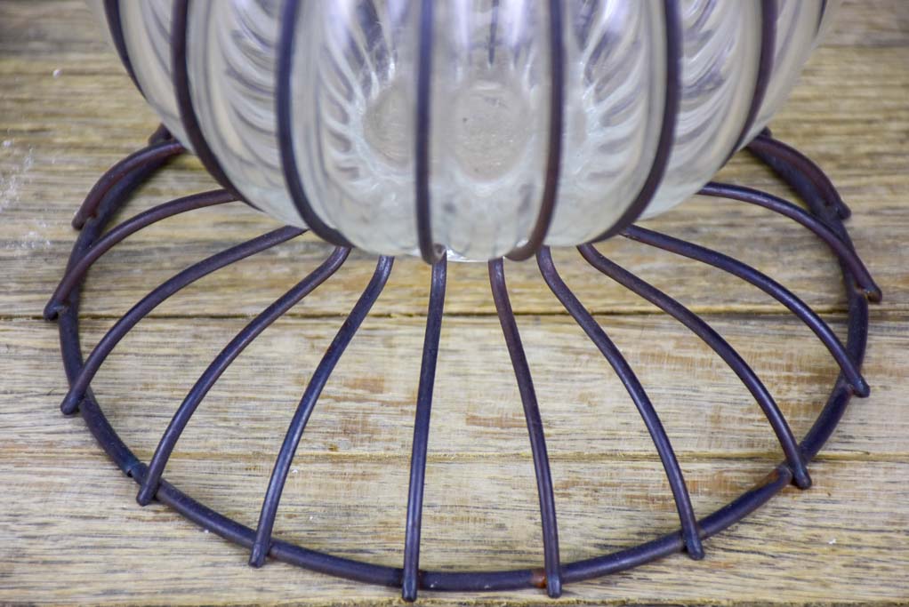 Tall blown glass vase in metal frame