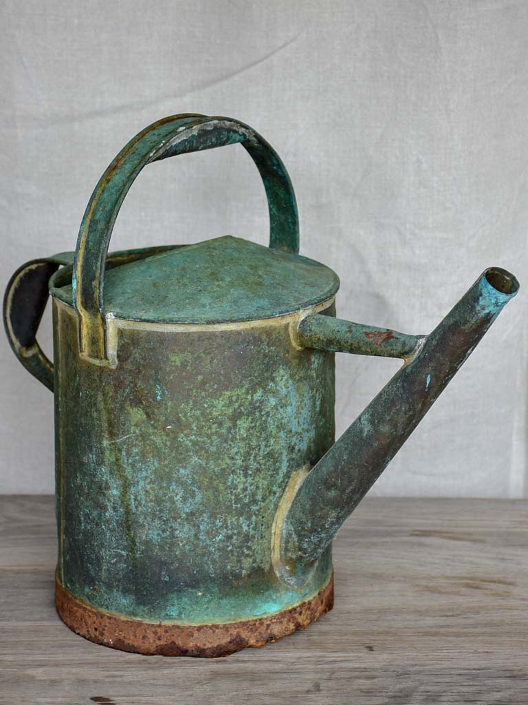 Antique French watering can with aqua patina