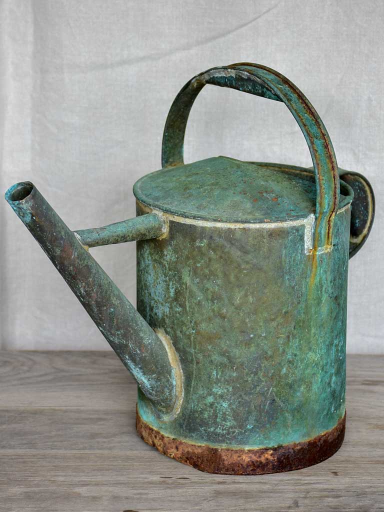 Antique French watering can with aqua patina