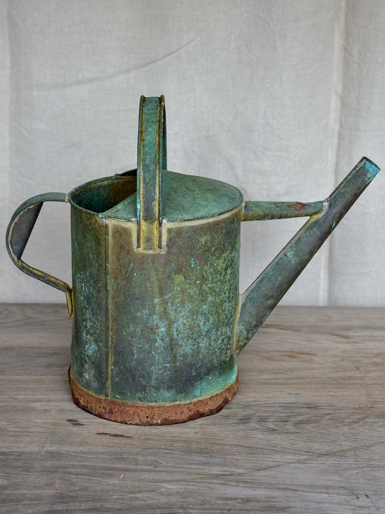 Antique French watering can with aqua patina