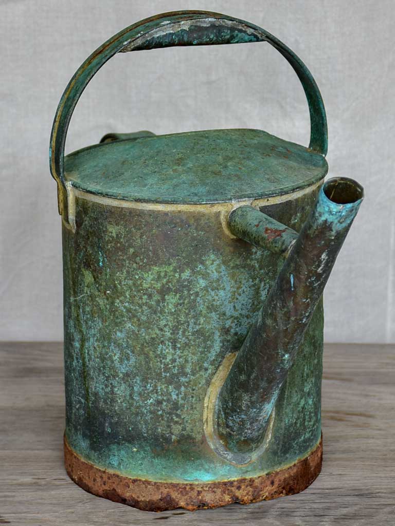 Antique French watering can with aqua patina