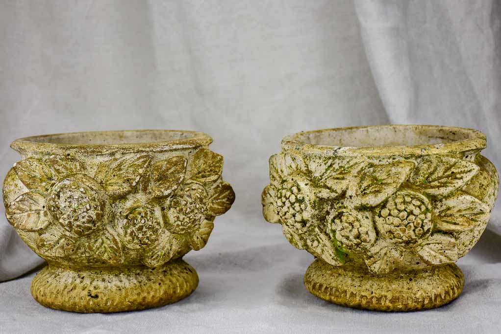 Pair of concrete flower pots decorated with pomegranates