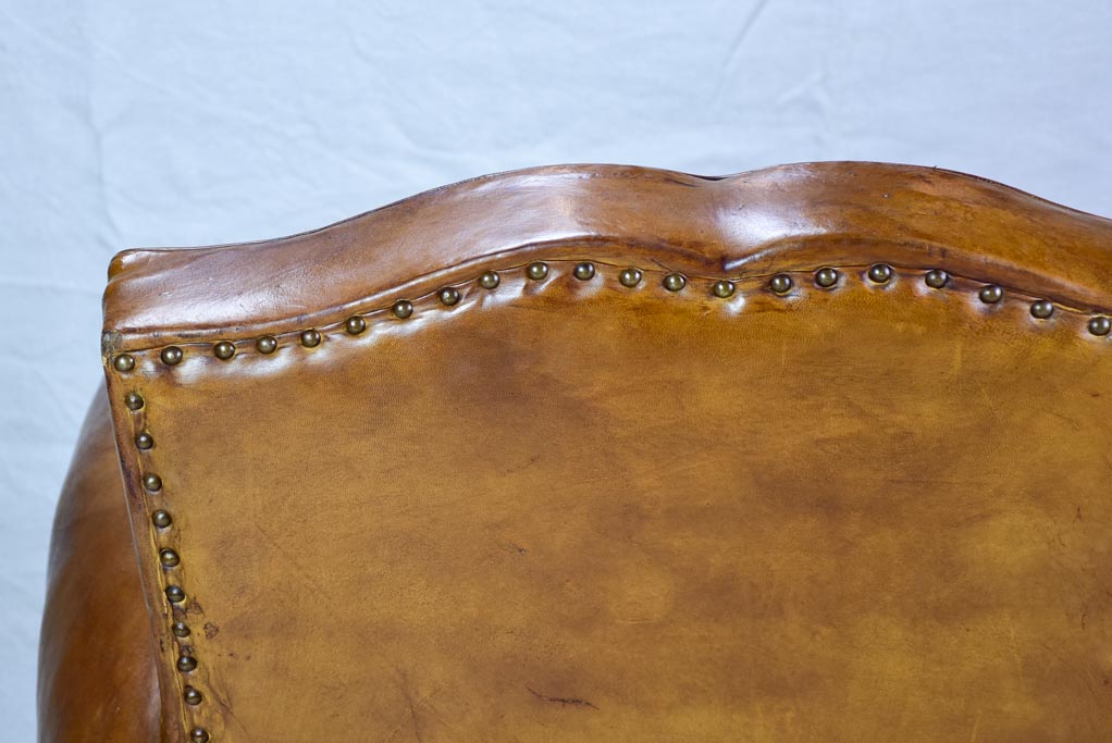 Large 1950's French leather club chair with mustache back and barrel arms