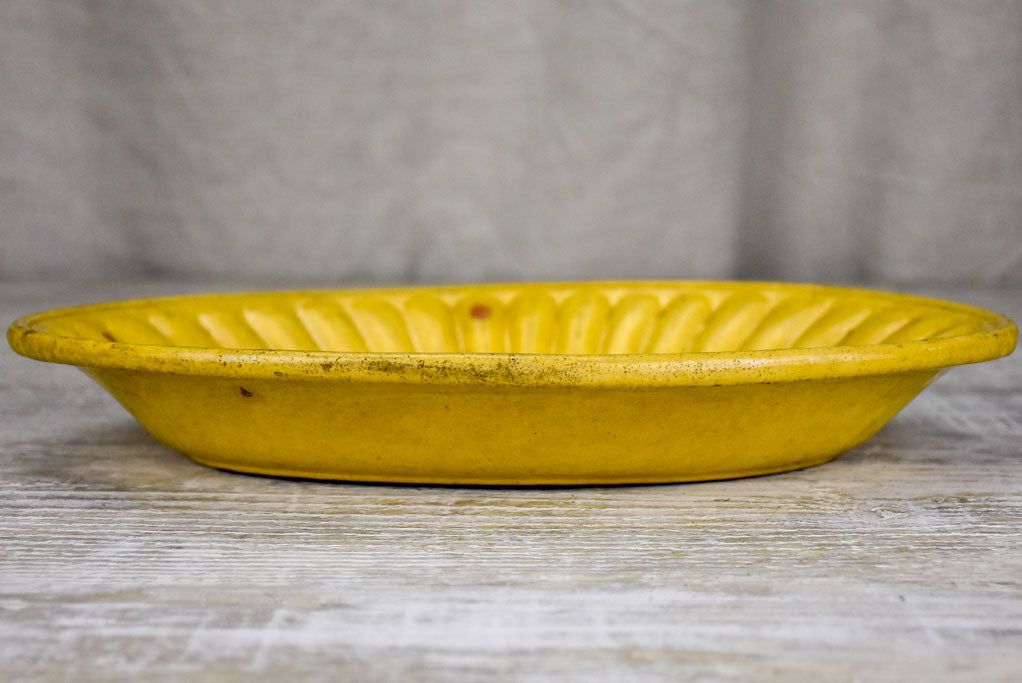 Yellow ware platter with rippled edge from south west France