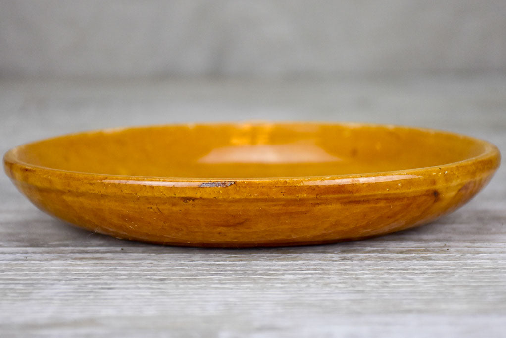 Set of seven mid-century plates with ocher glaze