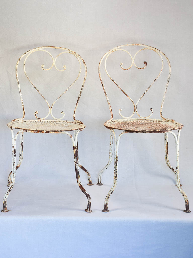 Pair of early twentieth century French garden chairs with white patina