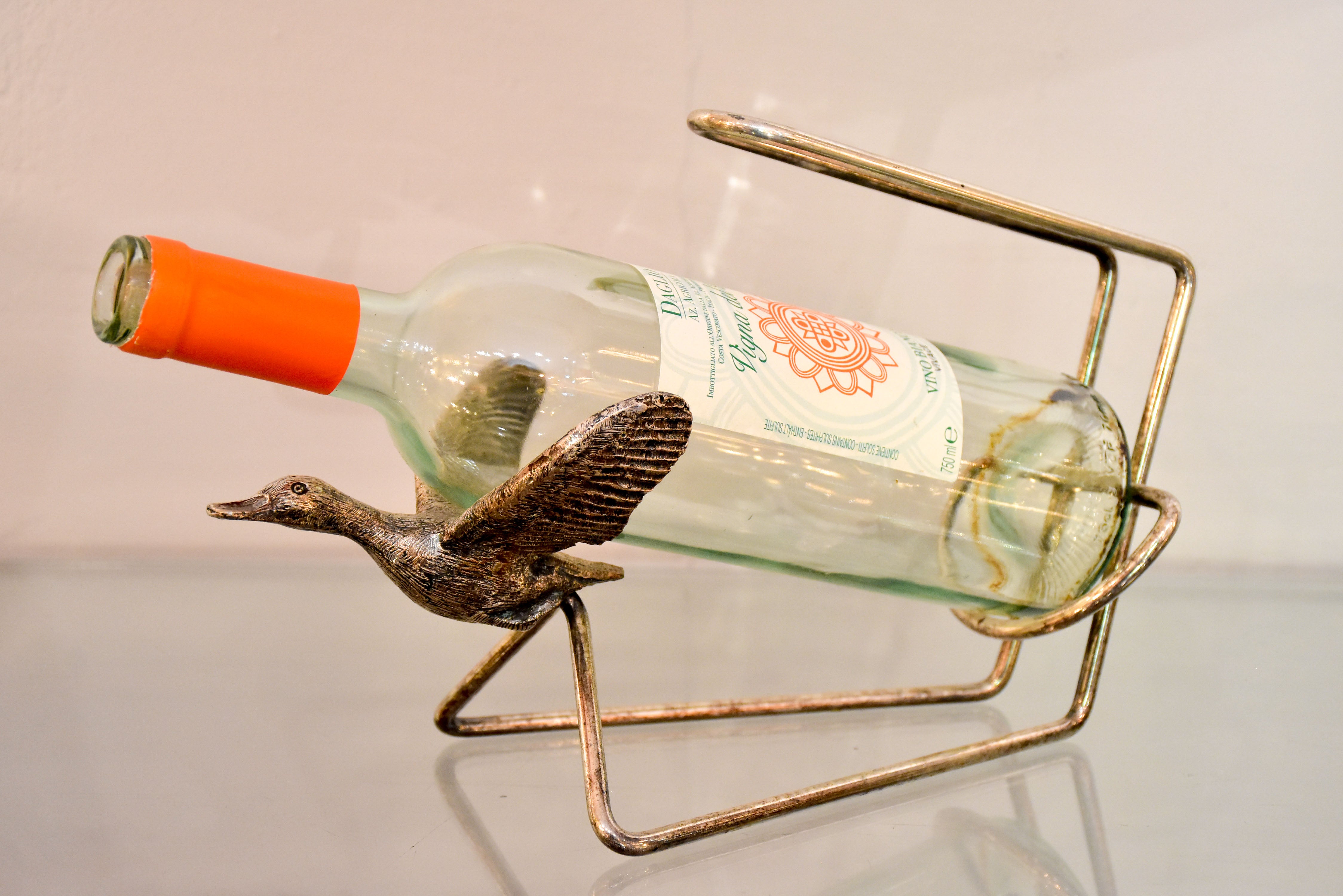 Vintage bottle stand with flying goose cradle