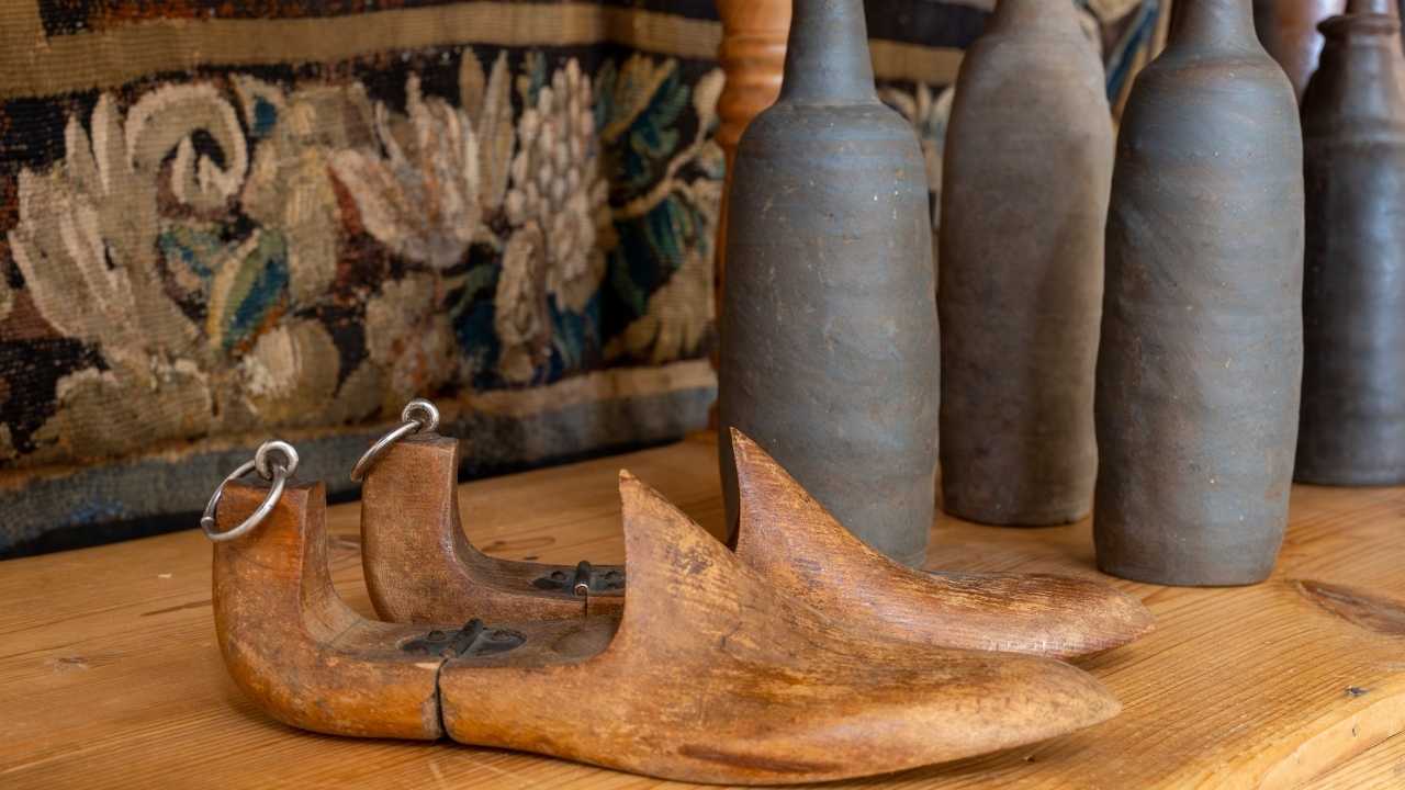 Lovely display of modern and antique memorabilia on a wooden table with ottoman beneath