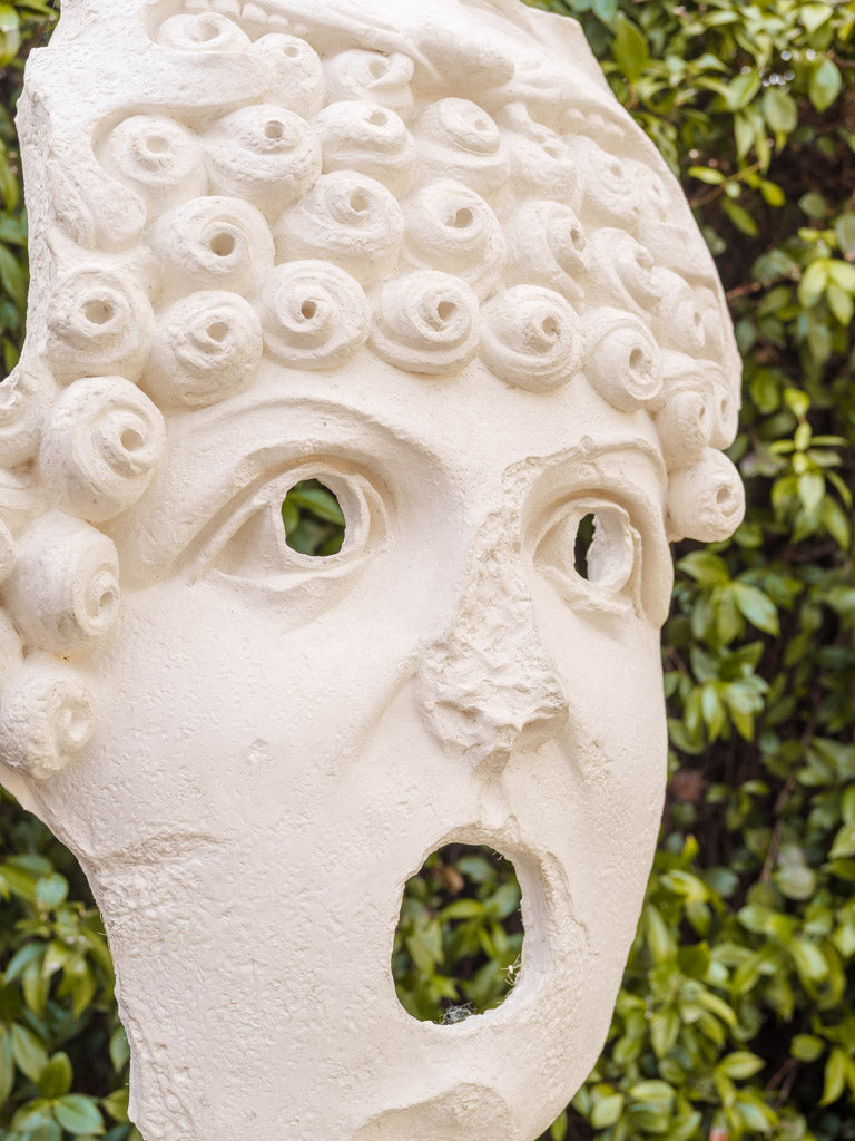 Artful stylized relief mask pair