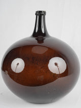 Antique amber-colored demijohn glass vase