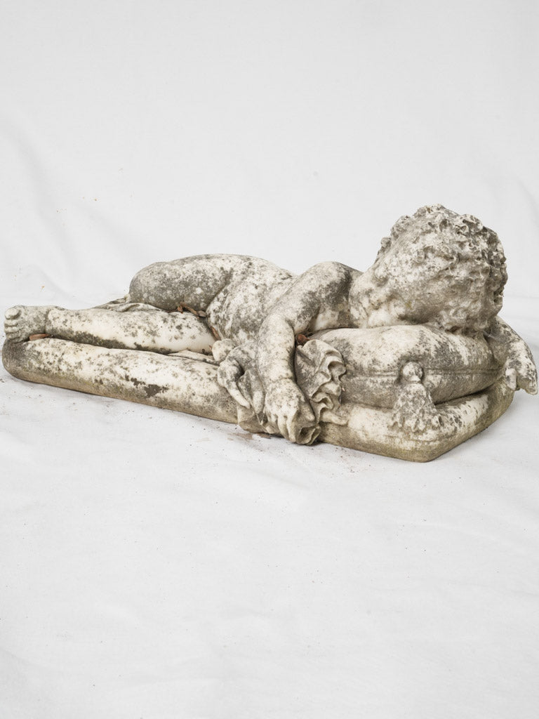 Weathered, antique sleeping cherub sculpture