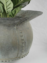 Button-riveted old copper cauldron traditional