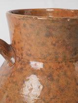 Aged French ceramic pitcher with vine motifs