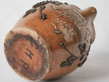 Antiquated, glazed vine motif ceramic pitcher