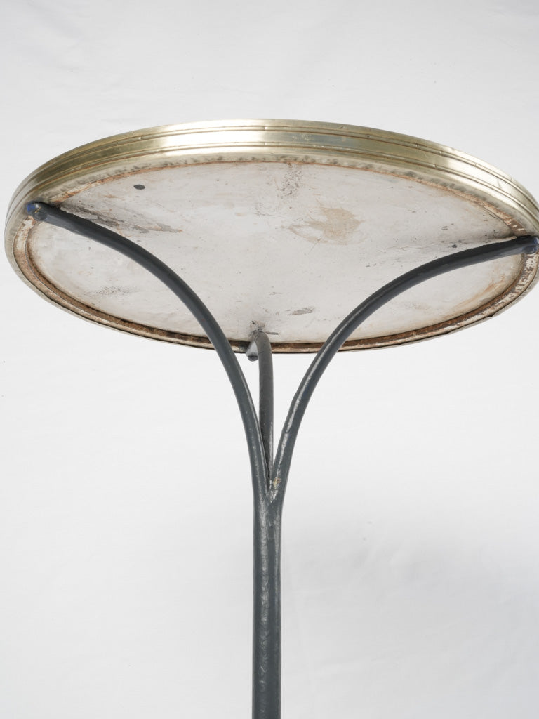 Aged brass-bound Parisian bistro table