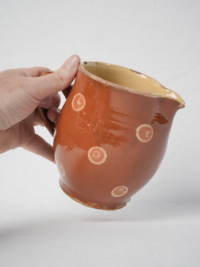 Rustic antique pitcher with chips