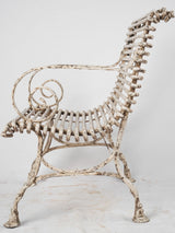 Elegant scrolled-armrest wrought-iron armchair