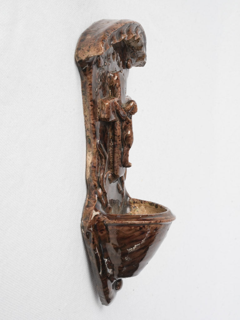 Rustic glazed earthenware holy water font