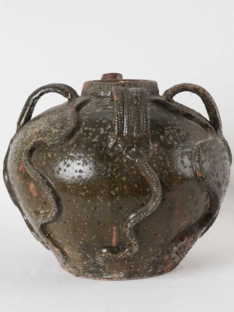 Walnut oil pitcher with snake motifs