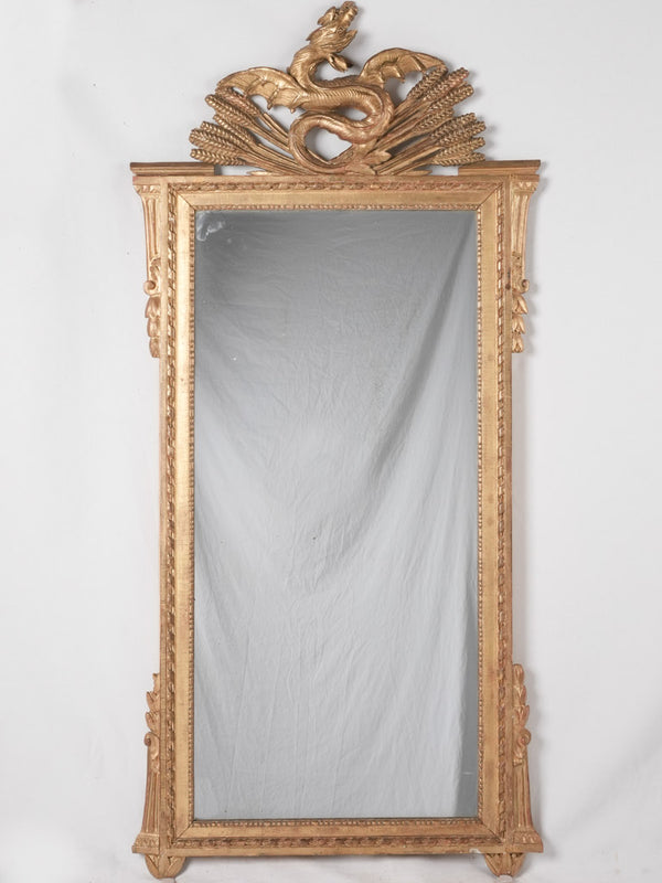 Gilded Louis XVI mirror w/ dragon pediment 63¾" x 29¼"