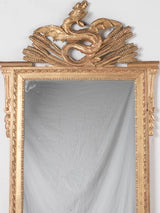 Gilded Louis XVI mirror w/ dragon pediment 63¾" x 29¼"