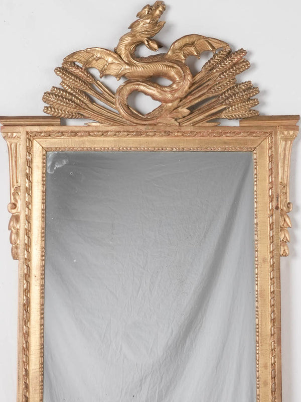 Gilded Louis XVI mirror w/ dragon pediment 63¾" x 29¼"