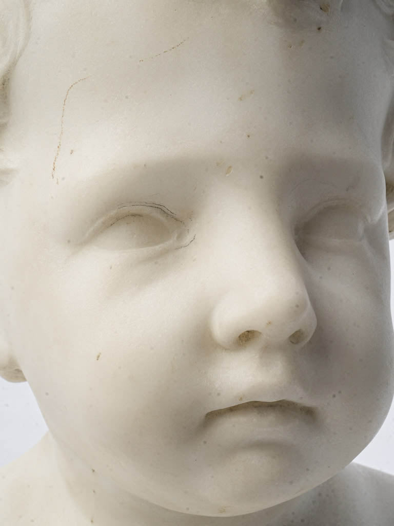 Intricately carved child bust