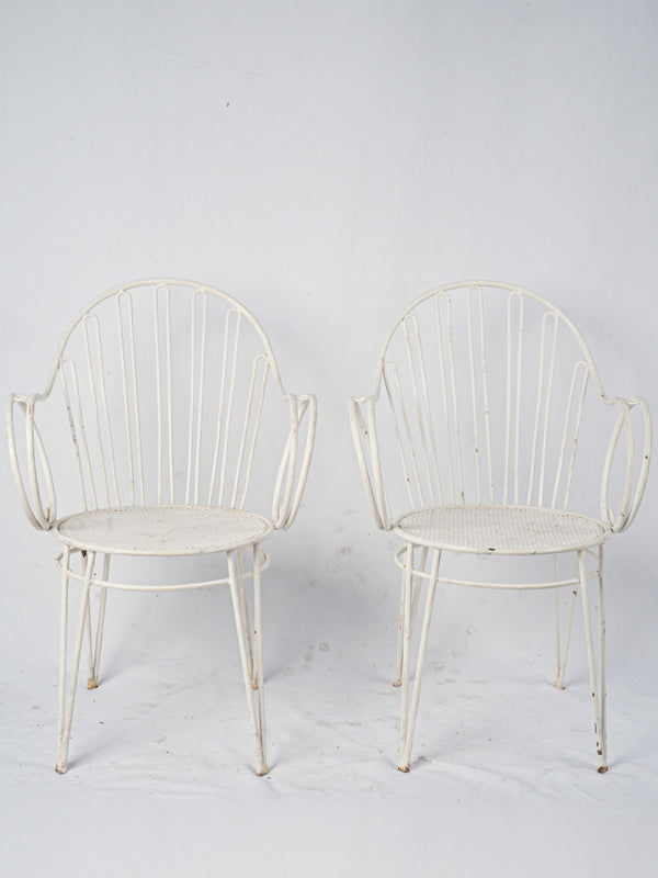 Weathered white vintage iron chairs