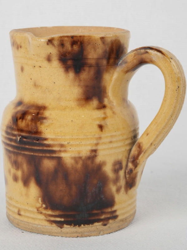 Antique yellow ceramic coffee pitcher