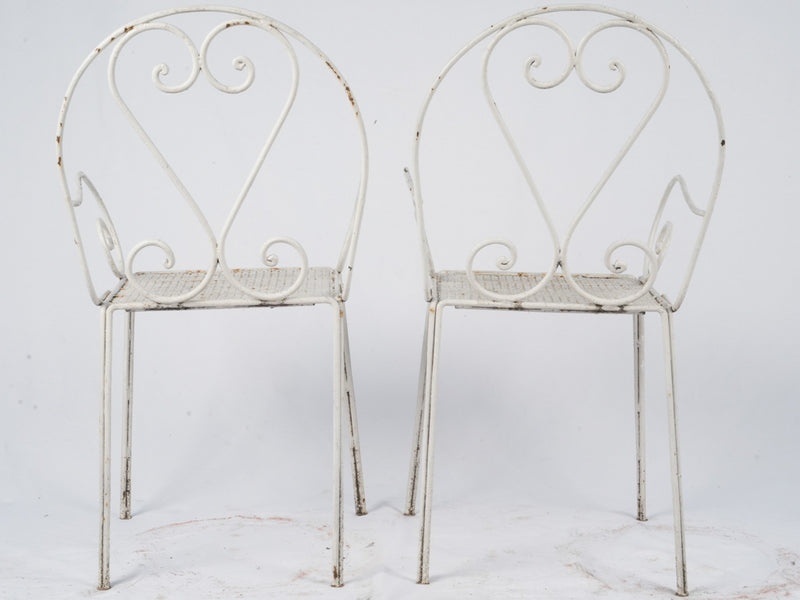 Whimsical aged French outdoor dining chairs