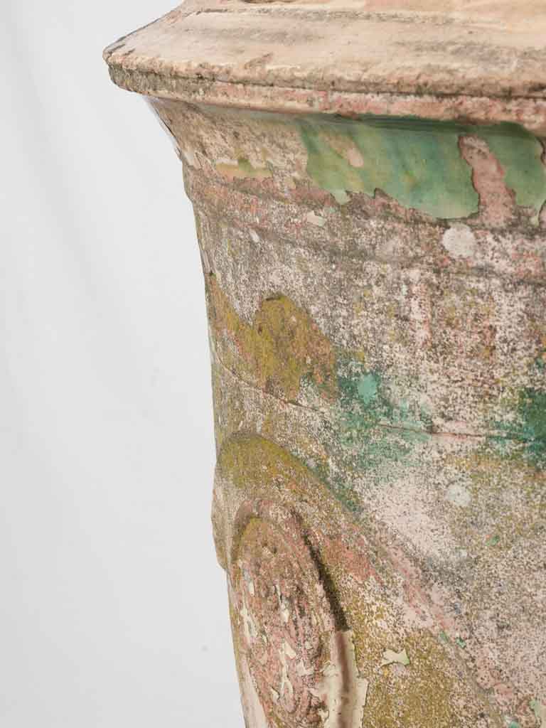 Aged terracotta urn with signature