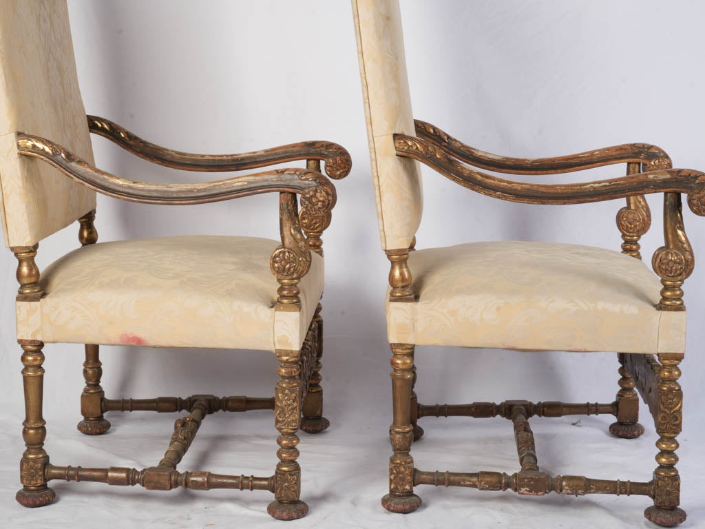 Patina-rich gilded flat-back chairs  