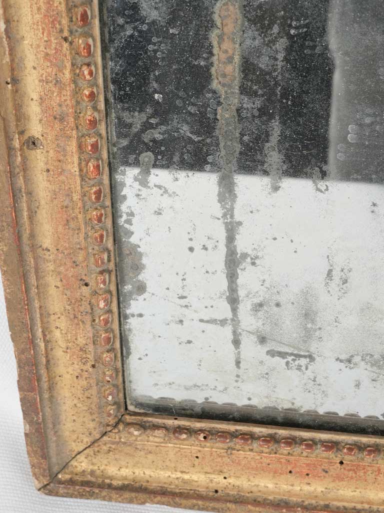 Elegant aged Louis XVI wall mirror