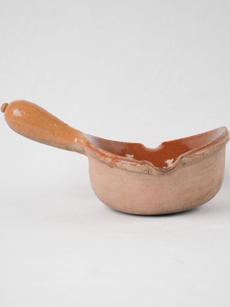 Vintage ocher-glazed clay cooking vessel