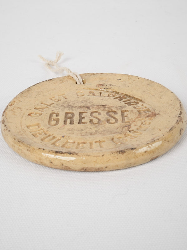 Vintage yellow GRESSE stamped advertisement disc