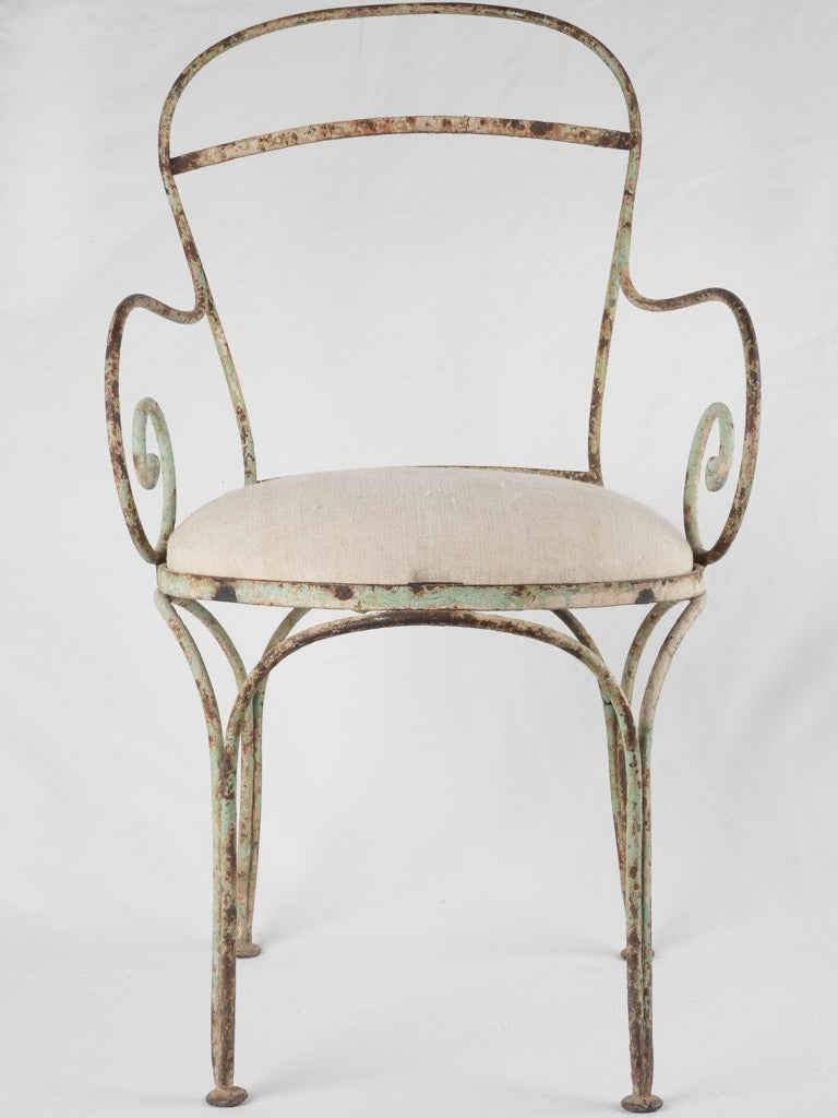 Upholstered 19th-century wrought iron armchair