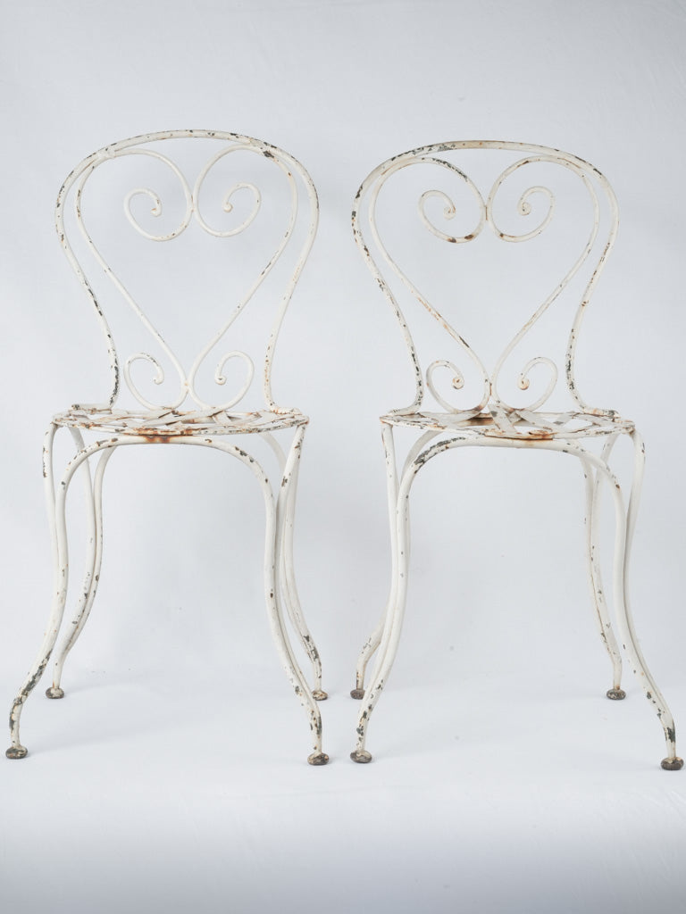 Vintage heart-shaped white garden chairs