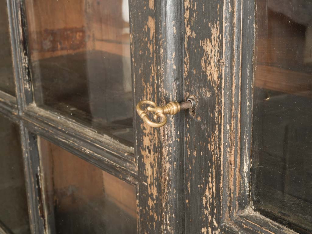 Glass-paneled worn finish cabinet