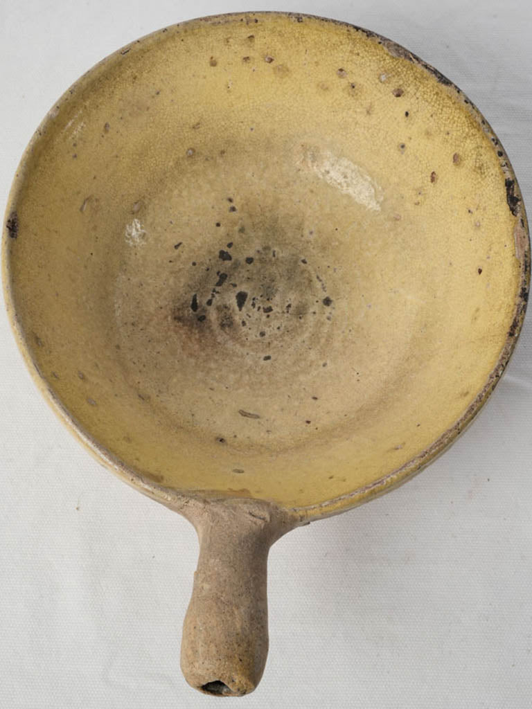 Soot-spotted terracotta cooking pan  