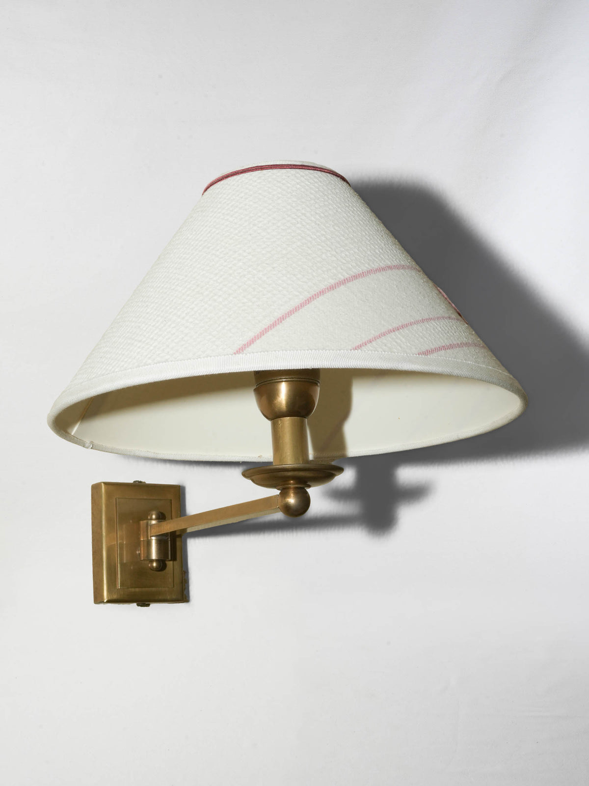 Pair of brass wall sconces with monogrammed ‘C’ shades
