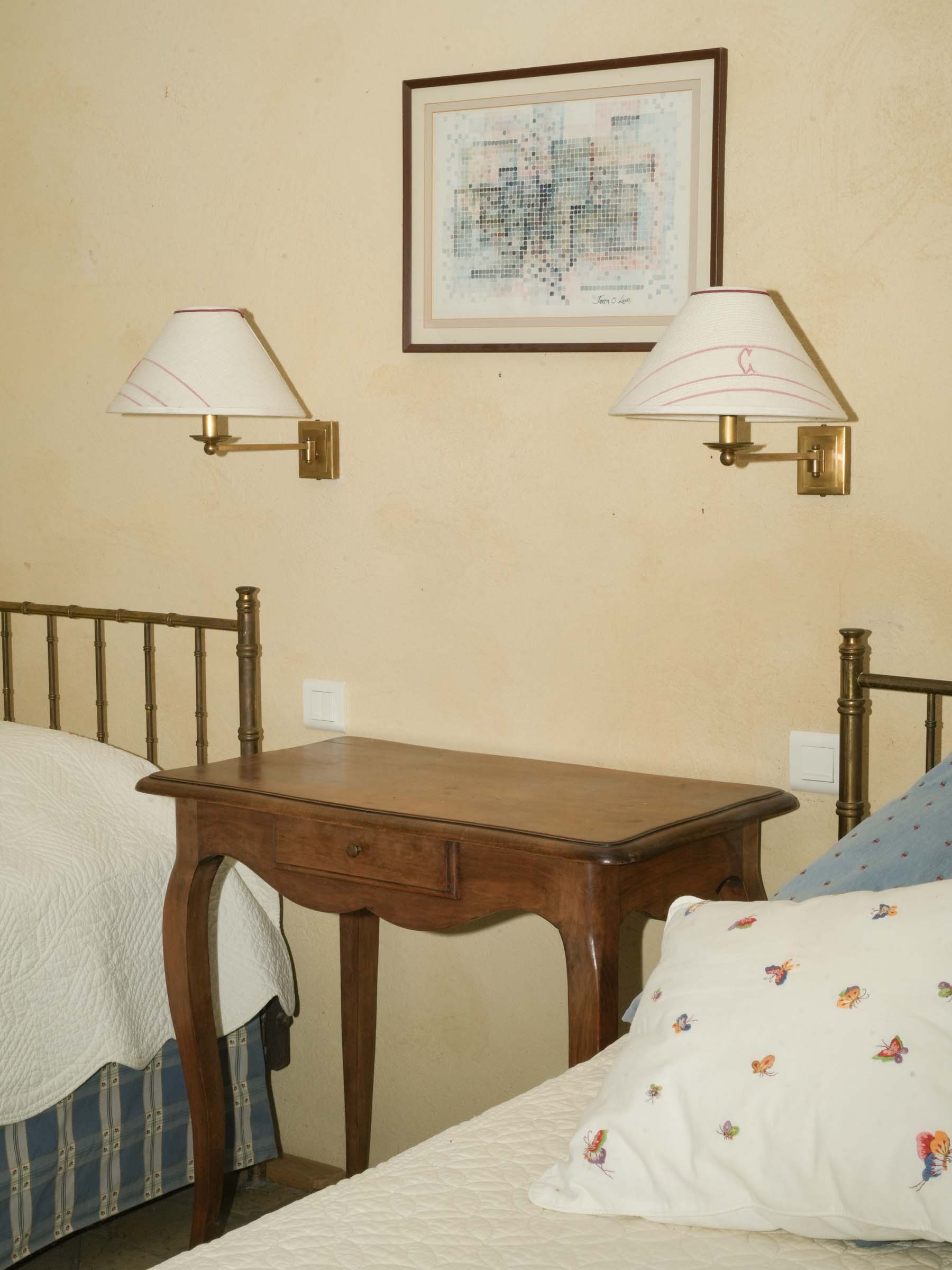 Pair of brass wall sconces with monogrammed ‘C’ shades
