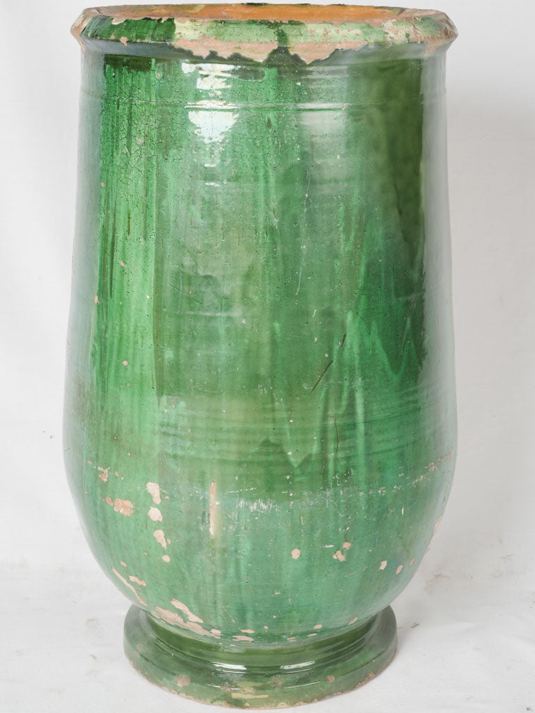 Upright, aged terracotta olive jar