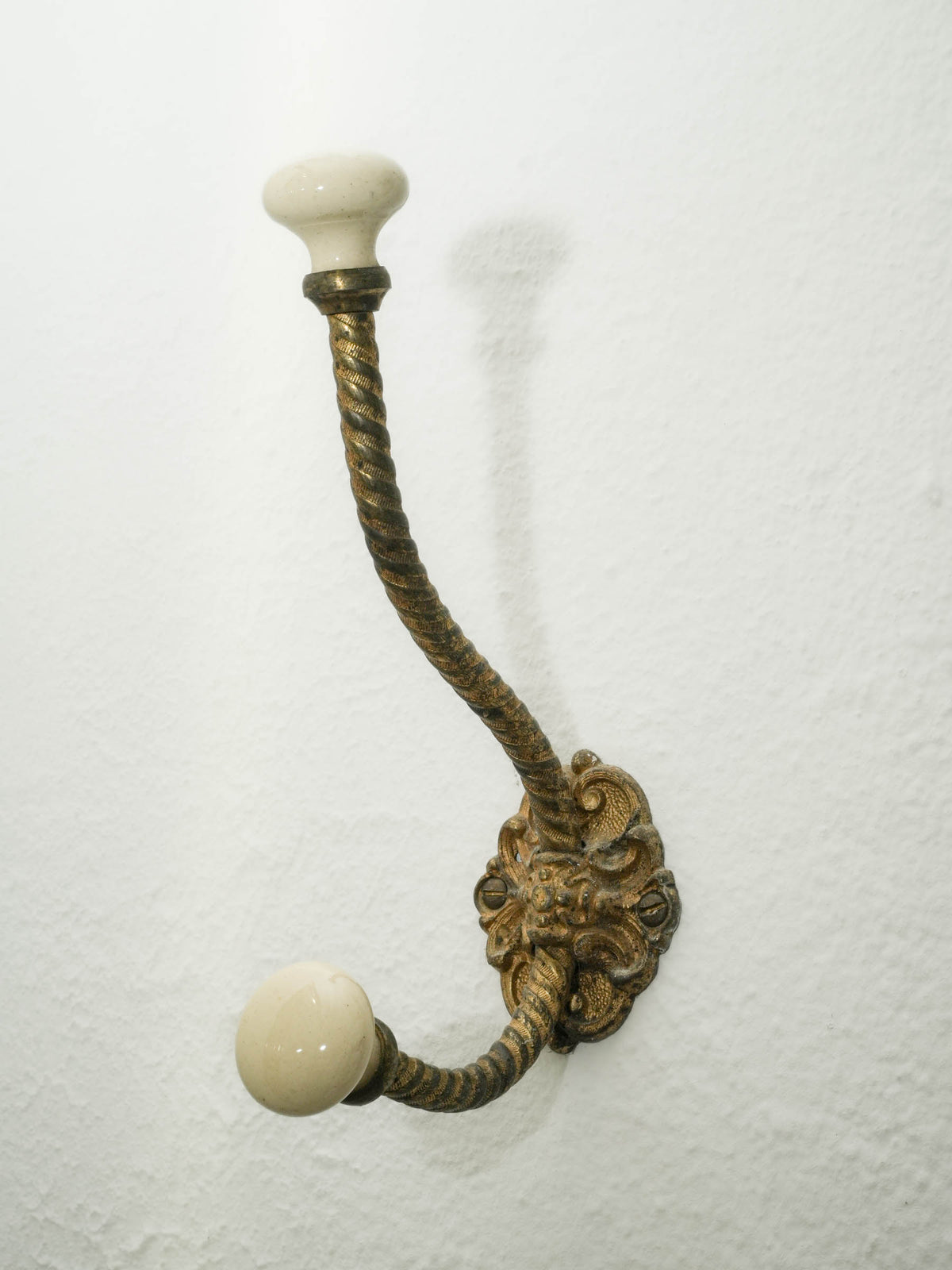 Brass Wall Hook with Porcelain Tips and Foliate Mount