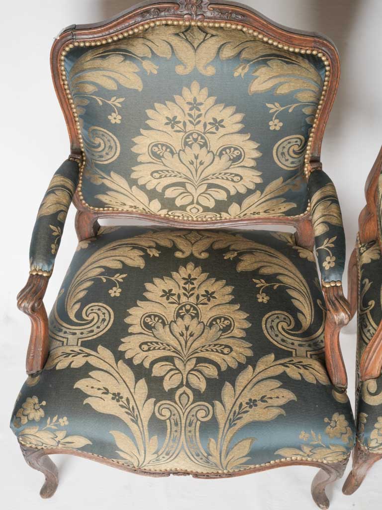 Intricately carved oak peacock silk armchairs