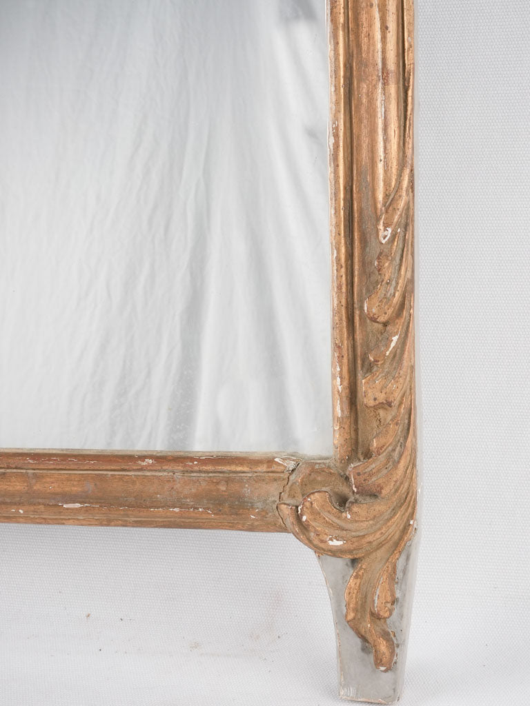 Aged giltwood decorative crest mirror