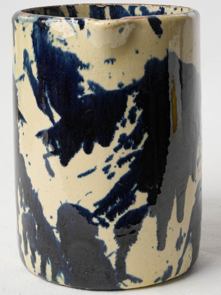 Artisanal blue-splashed pottery pitcher  