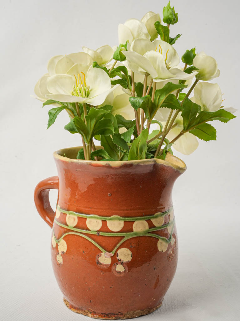 Antique terracotta pitcher with spots