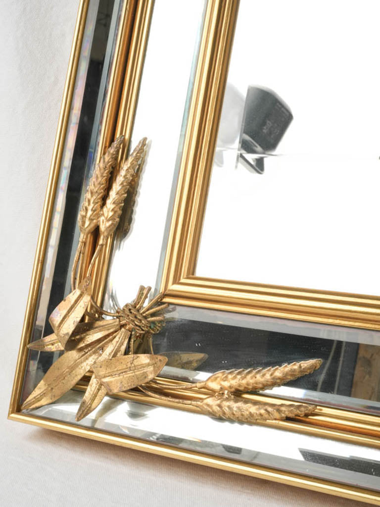 Antique mirror featuring wheat sheaves.